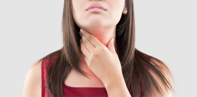 A woman feeling the lymph nodes in her neck